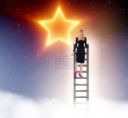 Photo for The businesswoman reaching out for stars in success concept - Royalty Free Image