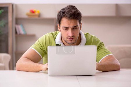 Photo for Young male freelancer working from home during pandemic - Royalty Free Image