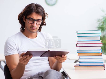 Photo for The young male student sitting in the classroom - Royalty Free Image