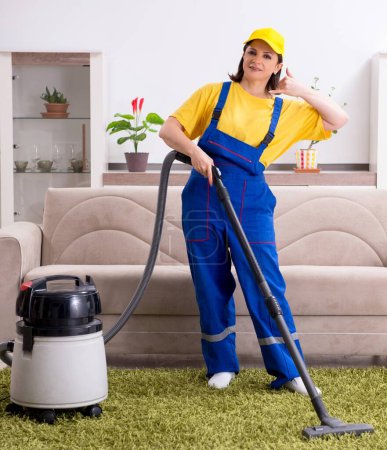 Photo for The old female contractor doing housework - Royalty Free Image