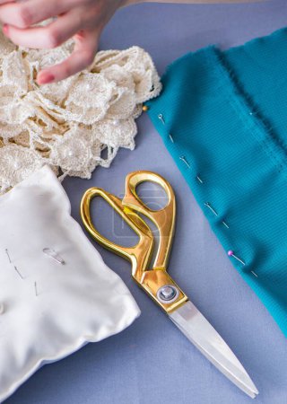 Photo for Woman tailor working on a clothing sewing stitching measuring fabric - Royalty Free Image