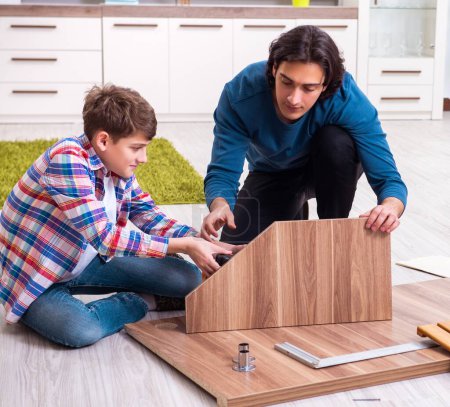 Photo for The young carpenter teaching his son - Royalty Free Image