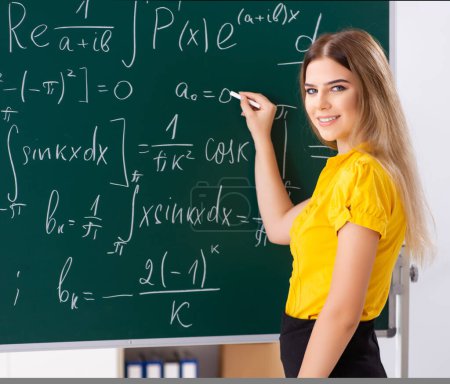 Photo for The young female student in front of the chalkboard - Royalty Free Image