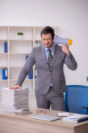 Photo for Young businessman employee holding megaphone in the office - Royalty Free Image