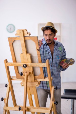 Photo for Young man enjoying painting at home - Royalty Free Image