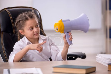 Photo for Little girl holding megaphone in the classroom - Royalty Free Image