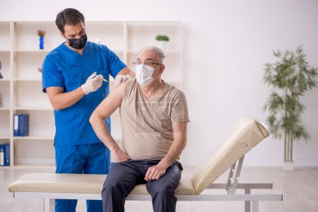 Photo for Old patient visiting young male doctor in vaccination concept - Royalty Free Image