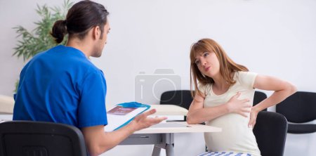 Photo for The pregnant woman visiting male doctor gynecologist - Royalty Free Image