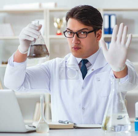 Photo for Young researcher scientist doing a water test contamination experiment in the laboratory - Royalty Free Image