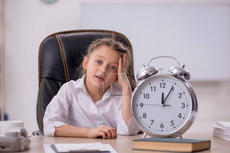 Photo for Little girl sitting in the classroom in time management concept - Royalty Free Image