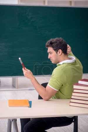Photo for Young student chemist sitting in the classroom - Royalty Free Image