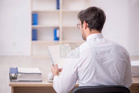 Photo for Young businessman employee sitting at workplace - Royalty Free Image