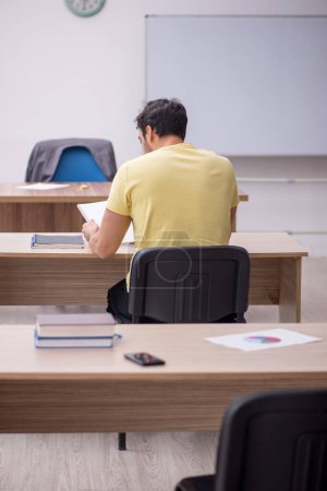 Photo for Young student teacher sitting in the classroom - Royalty Free Image