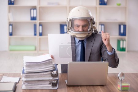 Photo for Old employee wearing spacesuit in the office - Royalty Free Image
