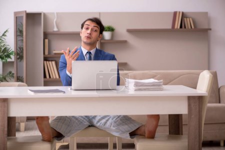 Photo for Young businessman employee working from home during pandemic - Royalty Free Image