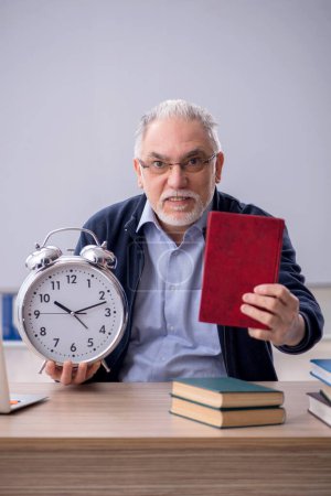 Photo for Old teacher in time management concept - Royalty Free Image