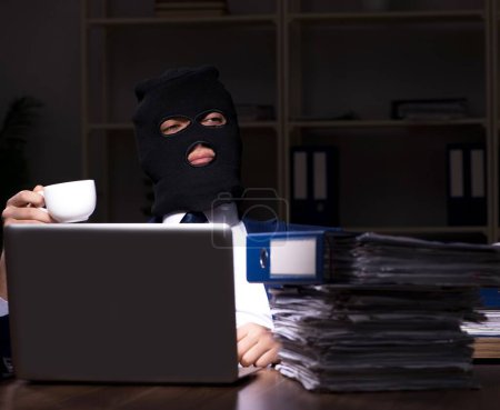 Photo for The male employee stealing information in the office night time - Royalty Free Image