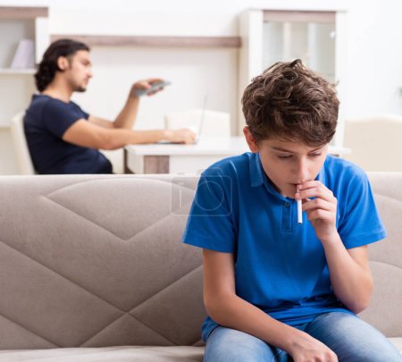 Photo for The concept of underage smoking with young boy and family - Royalty Free Image