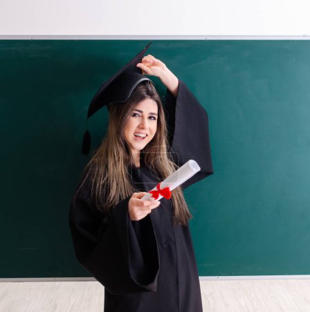 Foto de The female graduate student in front of green board - Imagen libre de derechos