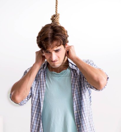 Photo for The young man preparing to commit suicide by hanging - Royalty Free Image