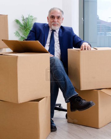 Photo for The aged businessman moving to new workplace - Royalty Free Image