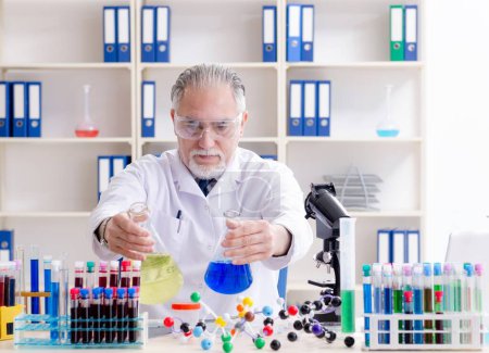 Photo for The old male chemist working in the lab - Royalty Free Image