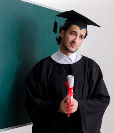 Photo for The graduate student in front of green board - Royalty Free Image