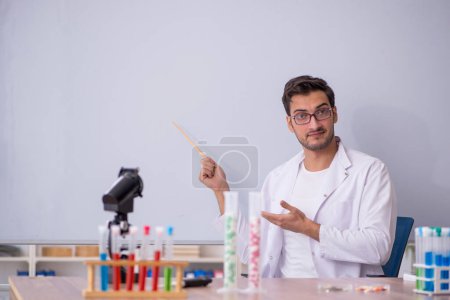 Photo for Young chemist in front of white board - Royalty Free Image