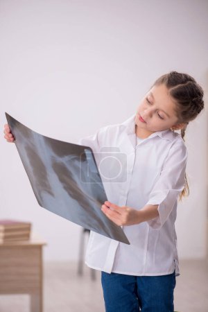 Photo for Little girl playing doctor radiologist at the hospital - Royalty Free Image