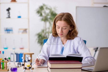 Photo for Young girl chemist student working at the lab - Royalty Free Image