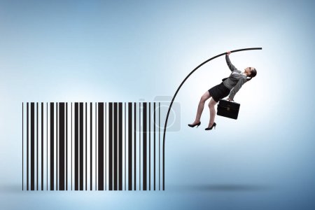 Photo for Businesswoman jumping over bar code in the pole vaulting - Royalty Free Image