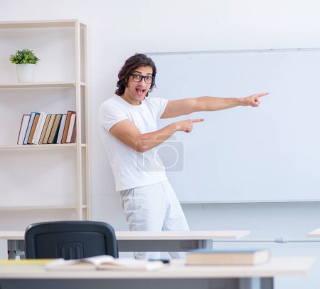 Photo for The young male student in front of whiteboard - Royalty Free Image