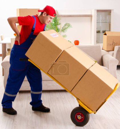 Photo for The young contractor with boxes working indoors - Royalty Free Image