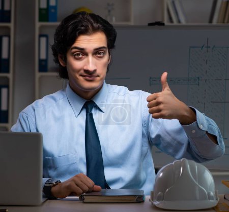Photo for The young male architect working night at office - Royalty Free Image