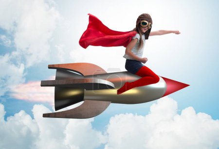 Foto de La niña volando cohete en concepto de superhéroe - Imagen libre de derechos