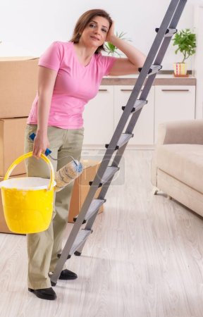 Photo for The middle-aged woman doing renovation at home - Royalty Free Image