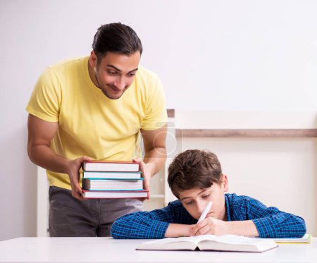 Photo for The father helping his son to prepare for school - Royalty Free Image