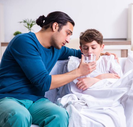 Photo for The young father caring for sick son - Royalty Free Image