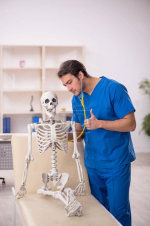 Photo for Young doctor and skeleton patient at the hospital - Royalty Free Image