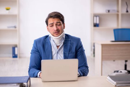 Photo for Young businessman employee after car accident in the office - Royalty Free Image