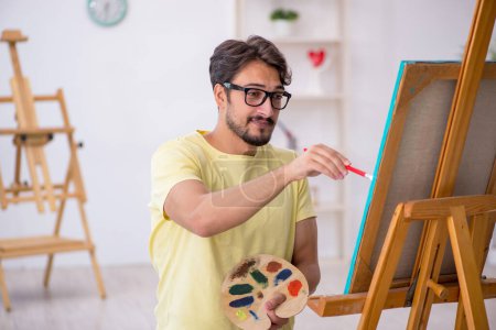 Photo for Young male painter enjoying painting at home - Royalty Free Image