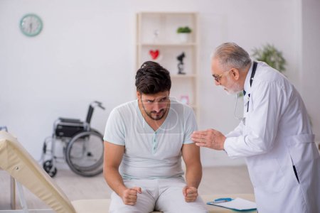 Photo for Young patient visiting old male doctor - Royalty Free Image