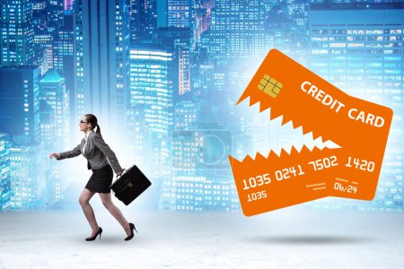 Foto de Businesswoman in the credit card debt concept - Imagen libre de derechos