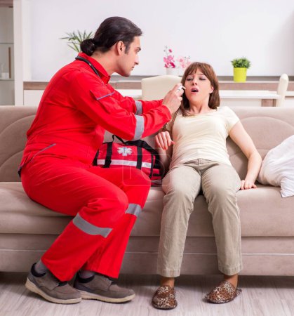 Photo for The young male paramedic visiting young woman - Royalty Free Image