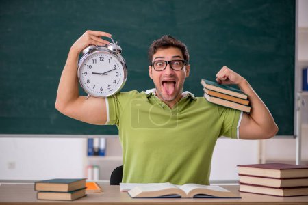 Photo for Young student in the classroom in time management concept - Royalty Free Image