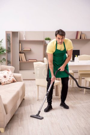 Photo for Young man cleaning the house - Royalty Free Image