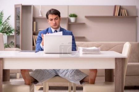 Photo for Young businessman employee working from home during pandemic - Royalty Free Image