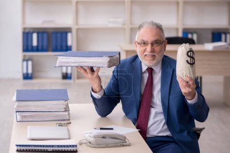 Photo for Old employee holding money bag - Royalty Free Image