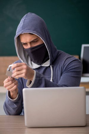 Photo for Young hacker sitting in the classroom - Royalty Free Image