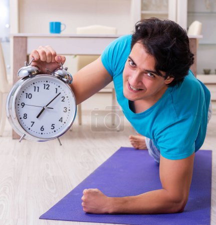 Photo for The young handsome man doing morning exercises - Royalty Free Image